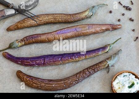 Stewed chinese eggplant and spice on wooden  surface top view Stock Photo