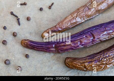 Stewed chinese eggplant and spice on wooden  surface top view Stock Photo