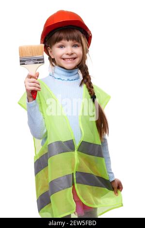 Smiling little girl in helmet and construction vest with paint brush on white isolated background Stock Photo