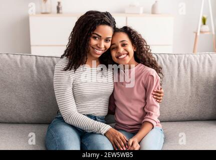 Portrait of black mother and daughter hugging Stock Photo