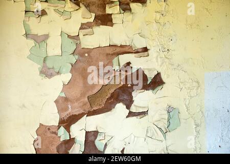 Paint peeling off a damp interior wall Stock Photo