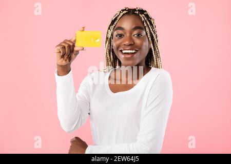 Black woman holding credit card and smiling Stock Photo