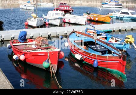 Small boats including traditional wooden fishing boat, in the harbour, Gardenstown, Aberdeenshire, Scotland Stock Photo