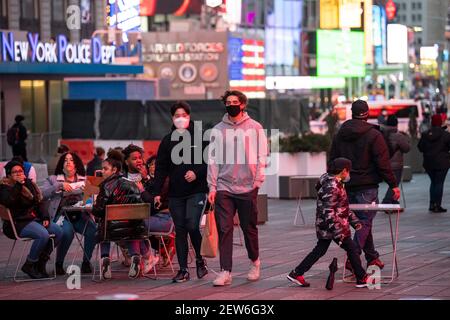 Manhattan, New York, USA. 28th Feb, 2021. Shoppers walk through an active Times Square in Manhattan, New York. Mandatory credit: Kostas Lymperopoulos/CSM/Alamy Live News Stock Photo