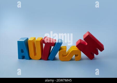 Autism awareness concept. Word autism on blue background. Stock Photo