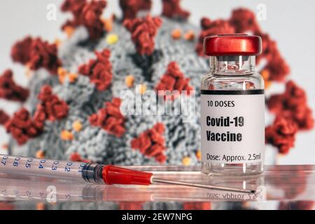 Vial of Covid-19 vaccine, syringe, and virus illustration Stock Photo