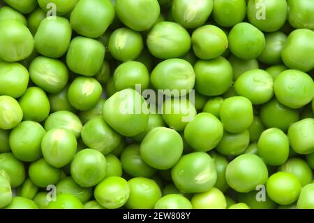 Fresh green peas background texture top view. Abstract food background. Stock Photo