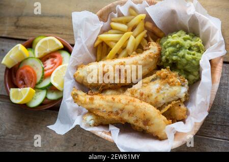 Fillets from whiting, Merlangus merlangius, that were line caught in the English Channel. They have been battered and deep fried to make a homemade po Stock Photo