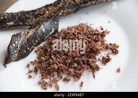 Venison from a wild fallow deer that has been air dried to make homemade biltong. It has been grated to make a topping for scrambled eggs. It was cure Stock Photo