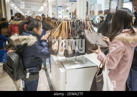 Hordes of shoppers throng the Michael Kors display at Macy's Herald Square  flagship store in New York on the day after Thanksgiving, Black Friday,  November 24, 2017. Michael Kors Holdings Ltd. announced