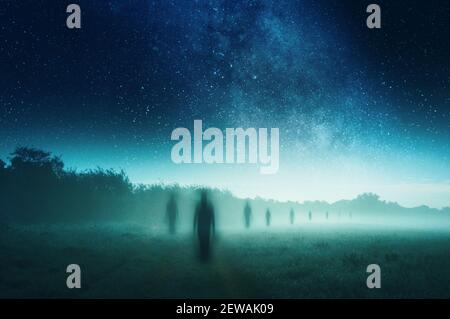 A horror concept, of a shadow like ghostly figures silhouetted against a misty landscape. On a spooky foggy winters night. With an artistic, textured Stock Photo