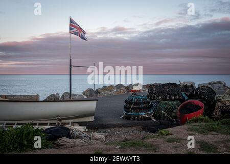Dusk at Beesands, South Devon.  Fishing equipment and union jack flag Stock Photo