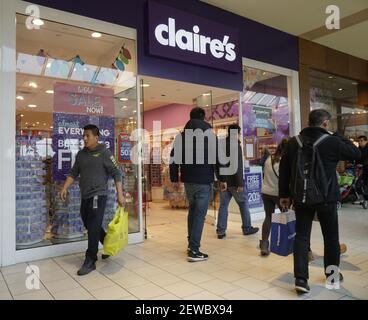 Shoppers pass Claire's in the Queens Center Mall in the borough of Queens  in New York on Sunday, December 17, 2017. Claire's is reported to be preparing  to file for bankruptcy protection as the company faces almost $2 billion in  debt. (Photo by Richard B