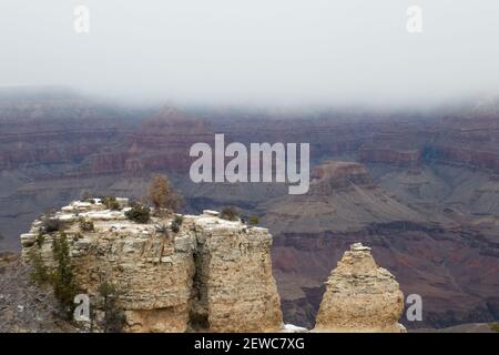 Look out over Grand Canyon rock formations in winter as snow cloud desecends Stock Photo
