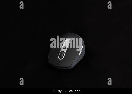 Black wireless mouse on black background Stock Photo
