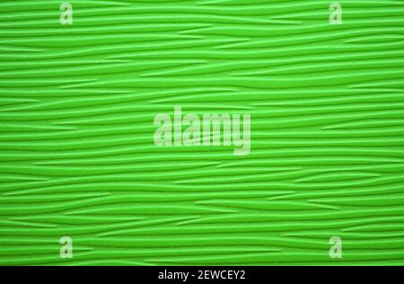 A fragment of natural wood with a textured wavy pattern, painted in bright green. Background, template. Stock Photo