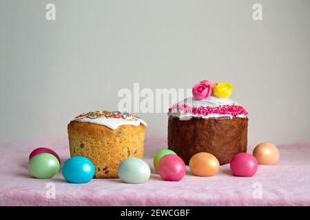 Traditional Slavic Easter cake decorated with sprinkles. Colored chicken eggs. Spring celebration event. Stock Photo