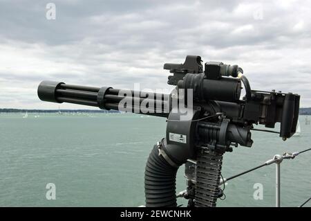 A machine gun on the side of a British Navy warship. Stock Photo