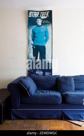 A vintage and worn Star Trek poster hanging above a couch in an abandoned apartment building. Ontario, Canada. Stock Photo