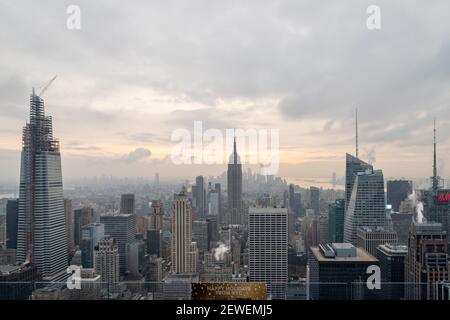 New York skyline from the top of  The rock observation deck in Rockefeller center sunset view with clouds in the sky