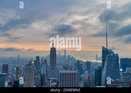 New York skyline from the top of  The rock observation deck in Rockefeller center sunset view with clouds in the sky Stock Photo