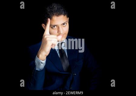 Young executive officer scolding his worker isolated on a black background. Stock Photo