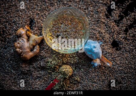 Shot of cumin seeds, sea salt, ginger powder,fennel seeds on brown surface for curing bloating. Stock Photo
