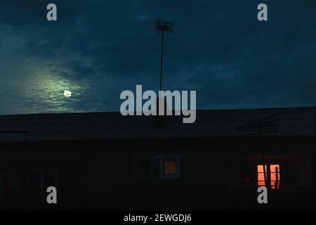 a scary house in a full moon at midnight. Halloween mood Stock Photo