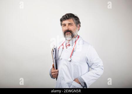 portrait of doctor with clipboard and stethoscope on white background Stock Photo