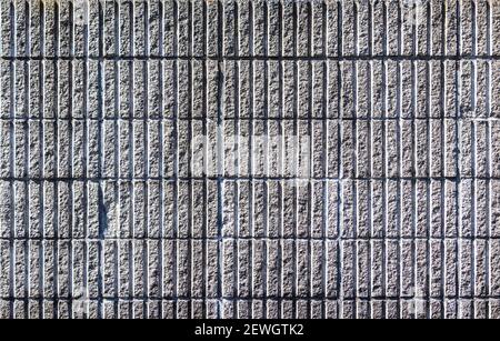 Vertically cemented bricks form a rough, grey wall, that in turn forms an ideal grunge background for your projects. Stock Photo