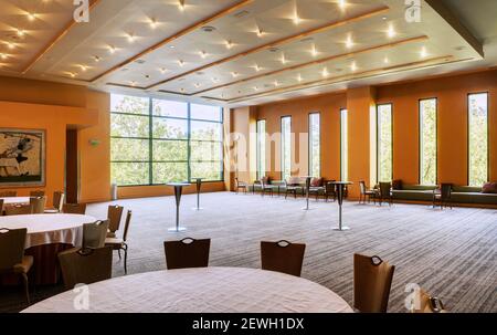 Large empty room in a hotel or conference centre, tables and chairs. Stock Photo