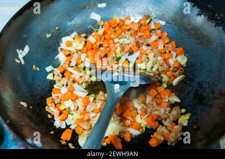 Cooking kimchi fried rice using Omipork a plant-based meat substitute in its ‘minced pork’ form. Stock Photo