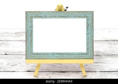 old wooden picture frame with easel on grungy white table Stock Photo