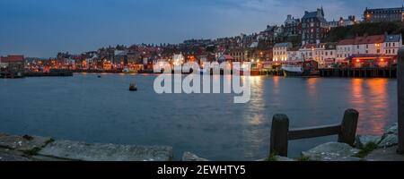 WHITBY, NORTH YORKSHIRE, UK - MARCH 18, 2010:  Panorama view across Whitby Harbour and waterfront at night Stock Photo