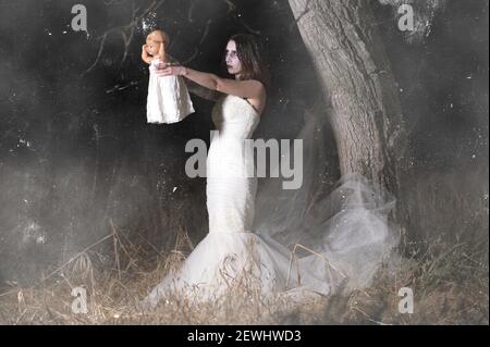 Horror Scene of a Woman Possessed holding a doll. High quality photo.