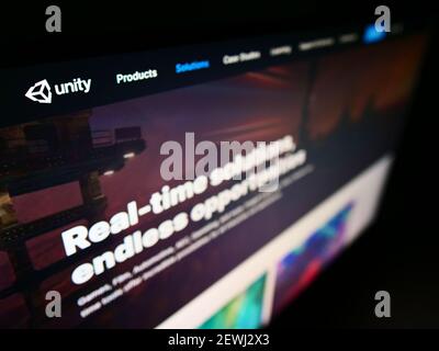 High angle view of website with logo of video game engine developer Unity Software Inc. (Unity Technologies) on monitor. Focus on top-left of screen. Stock Photo