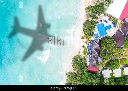 Symbolic picture vacation travel traveling luxury villa sea airplane flying Seychelles aerial photo beach waves.