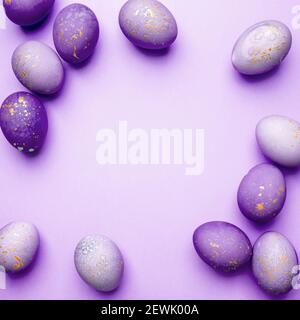 Easter frame of eggs painted in purple color. Stock Photo