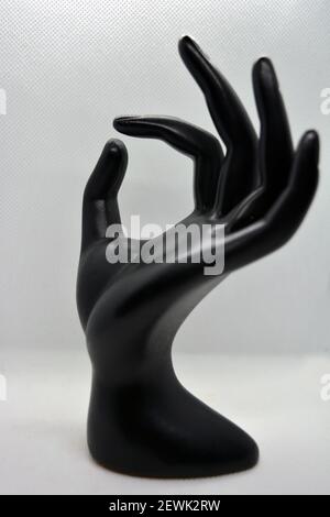 Black Ceramic Statue Of Female Hand, Female Wrist Located On A White 