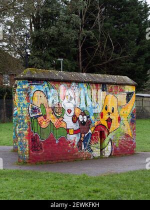 Graffiti covered brick wall in childrens' playground in Greenspace Park, Westbury, Wiltshire, England, UK. Stock Photo