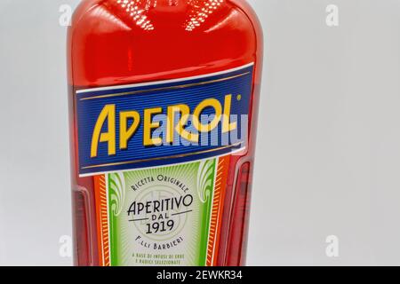 KYIV, UKRAINE - DECEMBER 16, 2020: Studio shoot of Aperol Aperitivo Liqueur bottle label closeup against white. Famous Italian aperitif produced by DC Stock Photo
