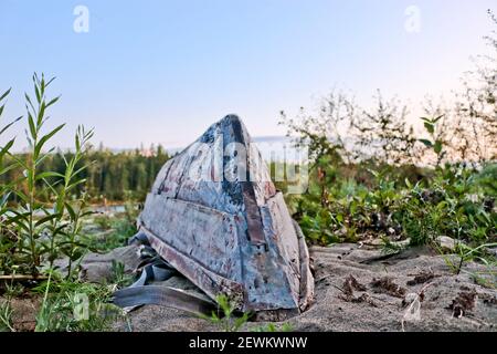 Old fishing rowboat on the sand on the river bank, Siberia, Russia. Stock Photo