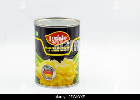 KYIV, UKRAINE - DECEMBER 24, 2020: Studio shoot of tin with Lorado pineapple slices in light syrup closeup against white background. Stock Photo