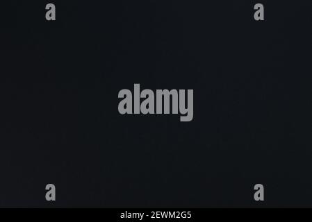 Black paper texture.  Black background. Matte monochrome surface. Stock Photo