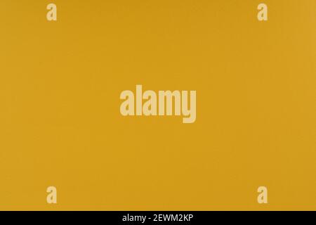 Yellow paper background. Goldenrod orange colour paper texture. Matte monochrome surface. Stock Photo