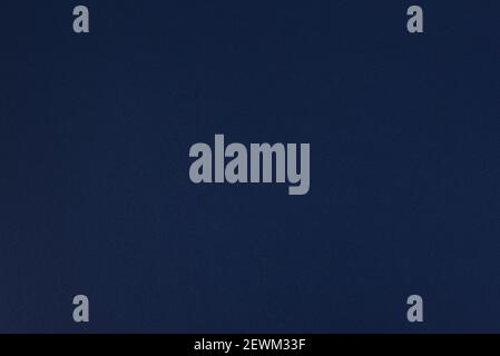 Dark blue paper background. Space blue colour paper texture. Matte monochrome surface. Stock Photo