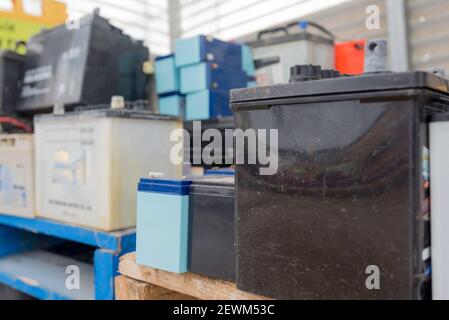Used lead acid car and truck batteries stacked and waiting for collection and recycling Stock Photo