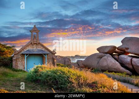 Chapel near Ploumanach at sunset in Perros-Guirec, Côtes d'Armor, Brittany, France Stock Photo