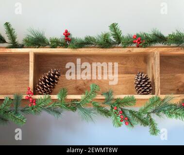 Border from decorative fir branches and red Christmas balls on a blue ...