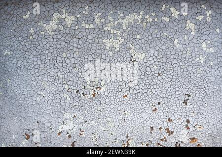Cracked texture. Old paint on the wall. Structural gray background of old paint Stock Photo